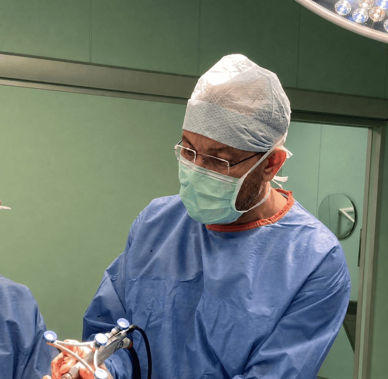 Dr. Papadopoulos guiding the CORI robotic instrument during surgery
