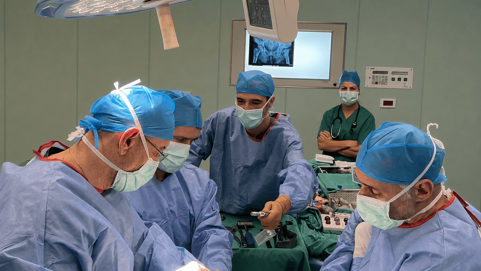 Surgical team performing hip navigation surgery, X-ray guidance visible